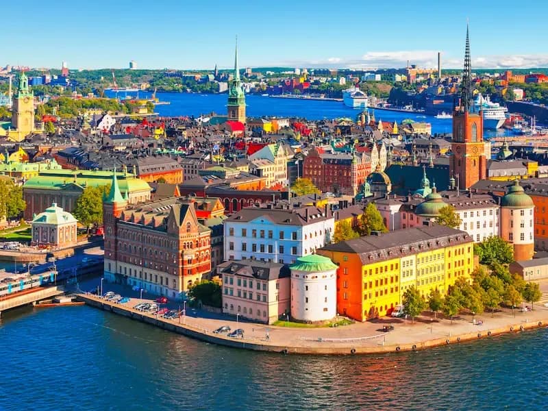 Colorful waterfront cityscape in Sweden with historic buildings and harbor views, reflecting the country’s e-invoicing landscape supported by DDD Invoices.