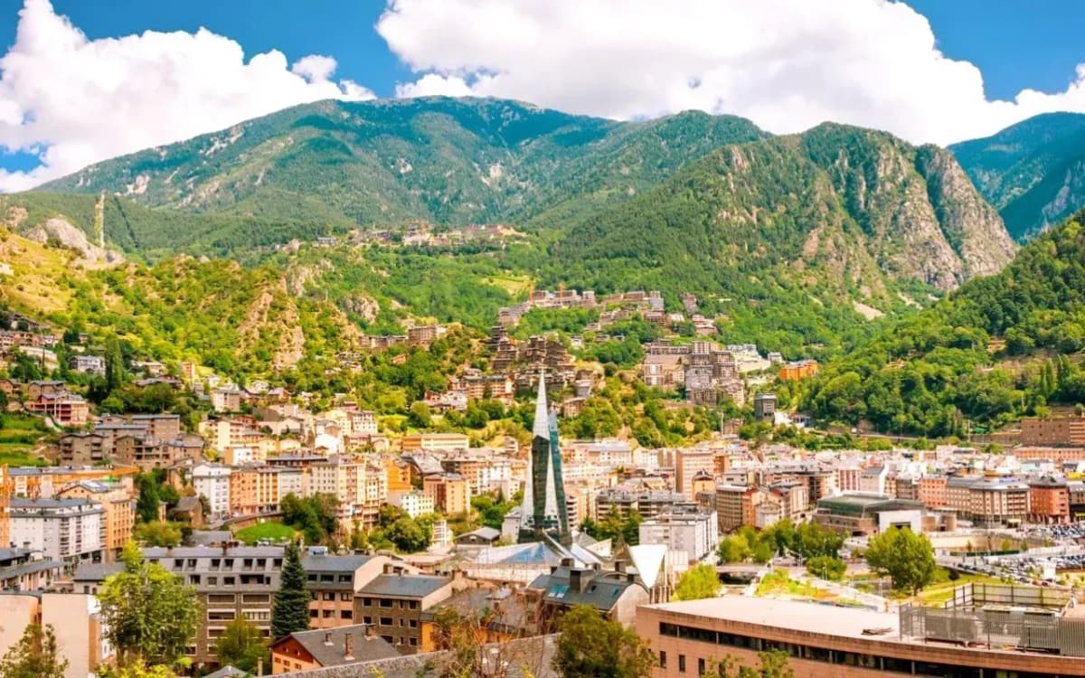 DDD Invoices supporting fiscalisation in Andorra, with a panoramic view of Andorra la Vella surrounded by green mountains and modern city buildings.