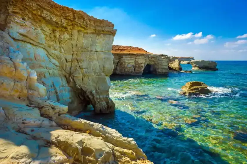 DDD Invoices supporting fiscalisation in Cyprus, with a scenic coastal view of limestone cliffs and clear turquoise Mediterranean waters.