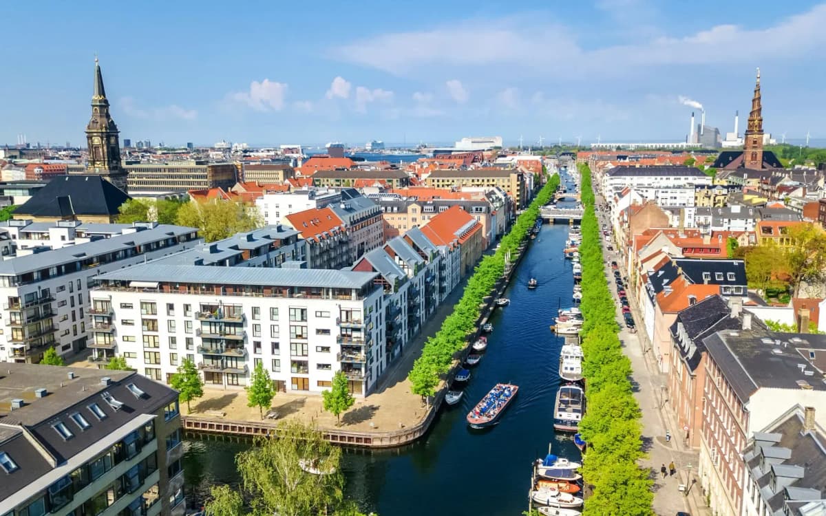 DDD Invoices supporting fiscalisation in Denmark, with an aerial view of Copenhagen’s canal lined with colorful buildings and boats.