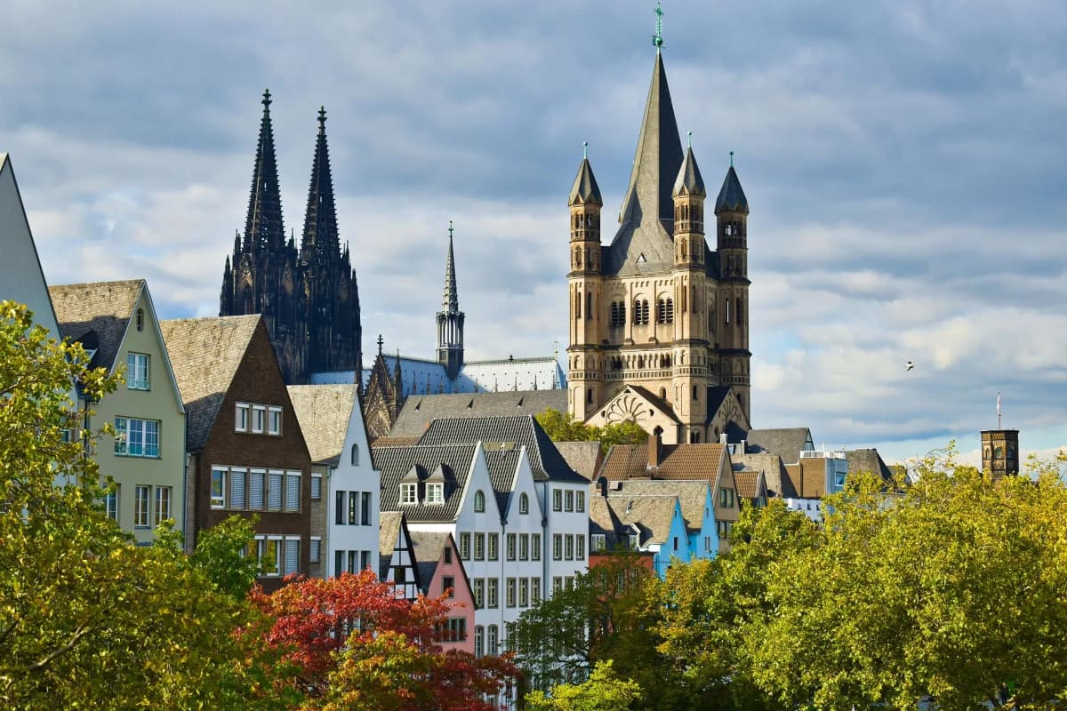 DDD Invoices supporting fiscalisation in Germany, featuring Cologne skyline with historic cathedral and colorful buildings.