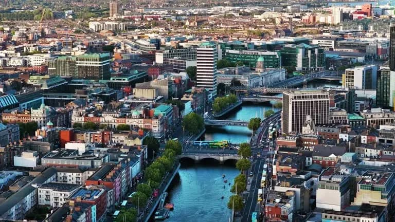Ireland’s fiscalization framework and real-time transaction reporting overseen by Revenue, supported by e-invoicing solutions from DDD Invoices, illustrated by an aerial view of Dublin