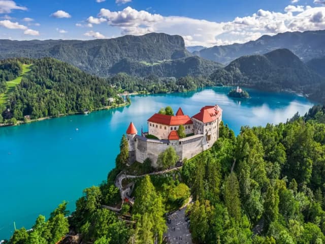 Alpine landscape with Lake Bled, illustrating how DDD Invoices supports fiscalization compliance for businesses operating in tourist-driven economies with real-time transaction reporting requirements.