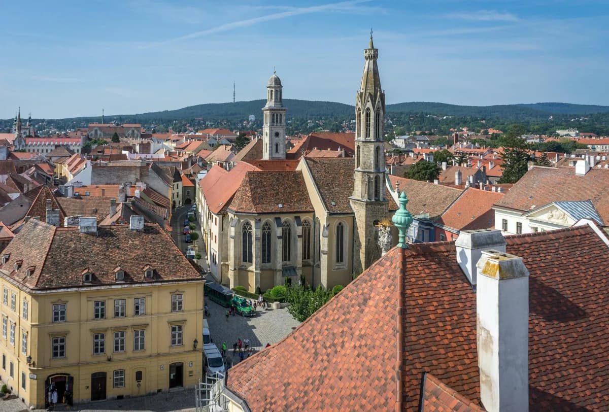 DDD Invoices supporting e-invoicing in Hungary, featuring a historic town with red rooftops and church towers under a clear sky.