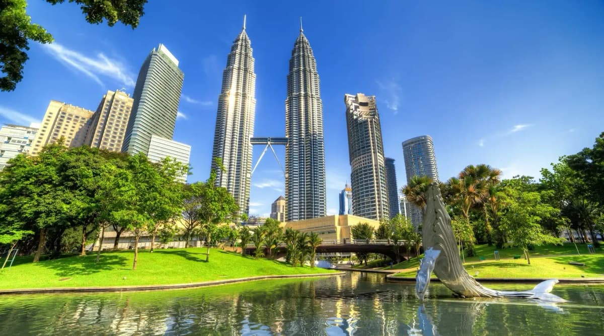 DDD Invoices supporting e-invoicing in Malaysia, with a city view of Kuala Lumpur featuring the Petronas Twin Towers and surrounding skyscrapers.