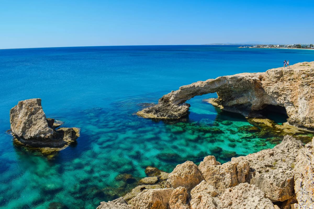 DDD Invoices supporting fiscalisation in Cyprus, with a scenic coastal view of limestone cliffs and clear turquoise Mediterranean waters.