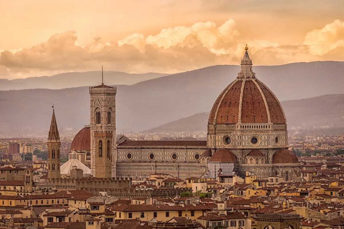 DDD Invoices supporting e-invoicing in Italy, featuring Florence skyline with the iconic cathedral dome under a warm sunset.