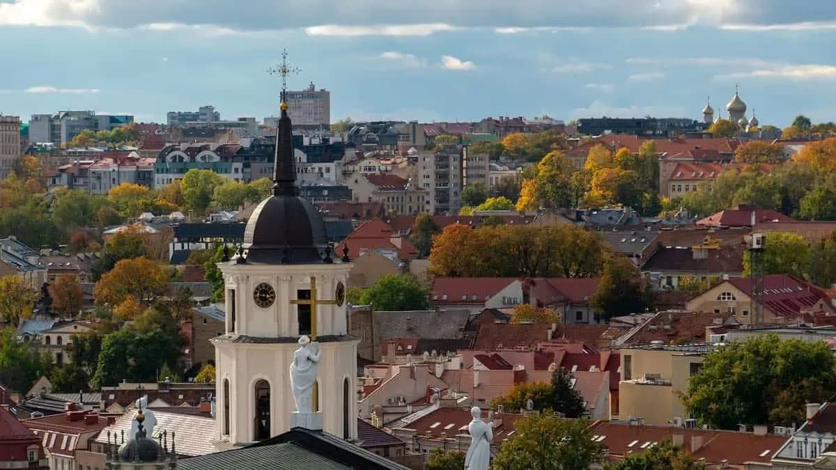 Historic cityscape in Lithuania with church towers and autumn foliage, reflecting the country’s e-invoicing environment supported by DDD Invoices.