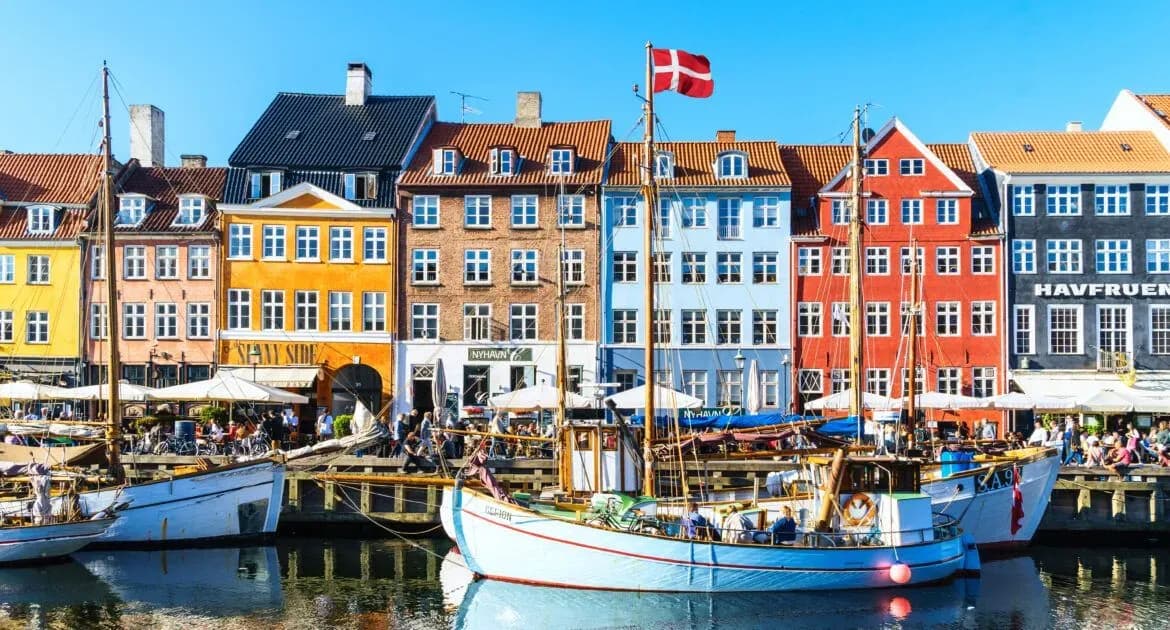 Colorful waterfront houses and boats in Nyhavn, Copenhagen, Denmark, a city embracing digital transformation where e-invoicing is expanding, with DDD Invoices providing seamless API integration solutions.