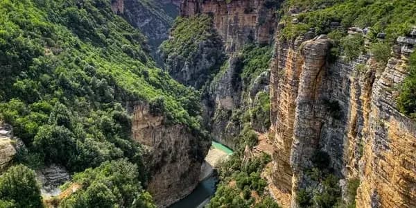 Scenic canyon in Albania with towering cliffs and a winding river, as the country advances toward mandatory e-invoicing supported by DDD Invoices’ API solution.