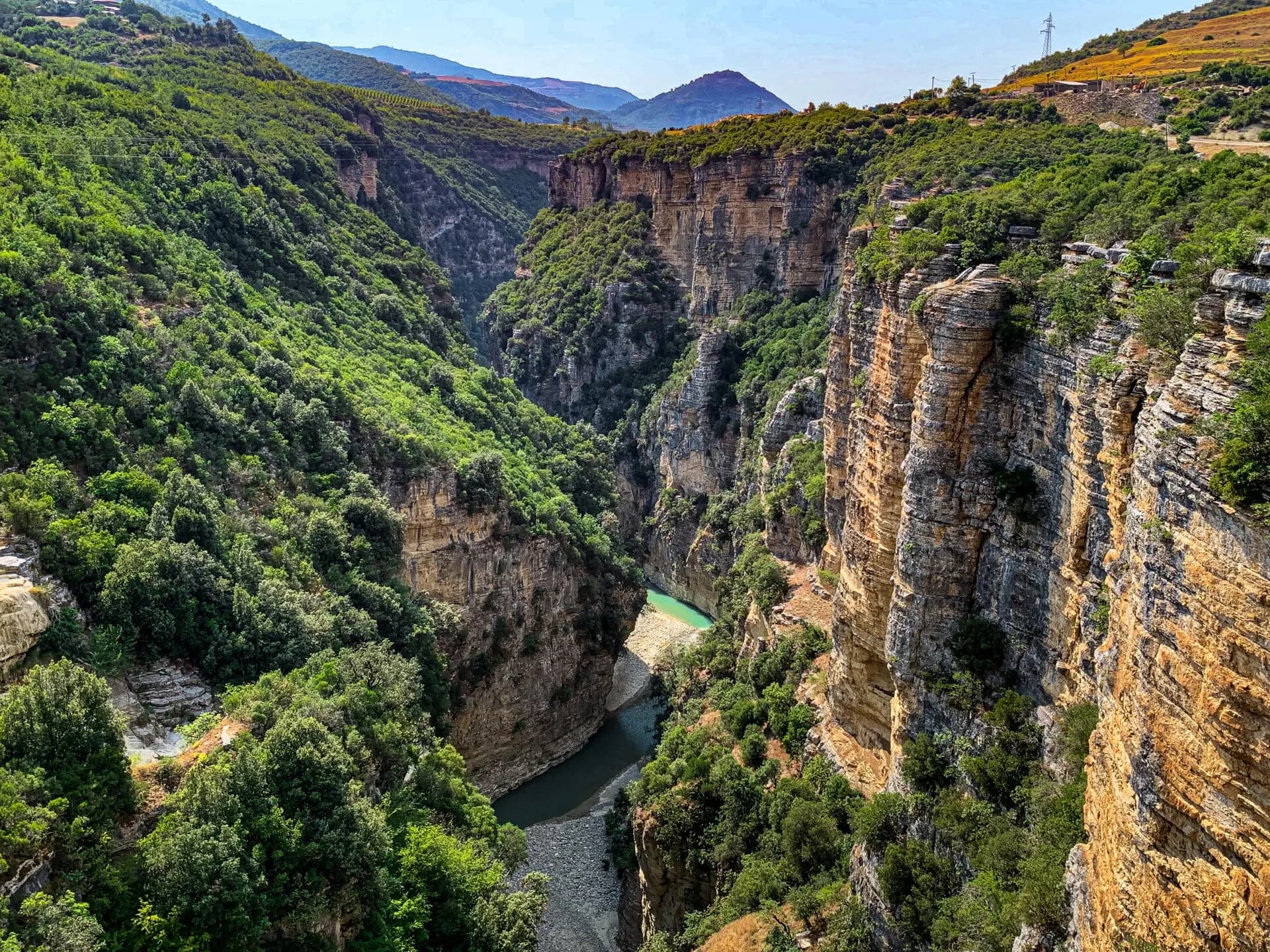 Scenic canyon in Albania with towering cliffs and a winding river, as the country advances toward mandatory e-invoicing supported by DDD Invoices’ API solution.
